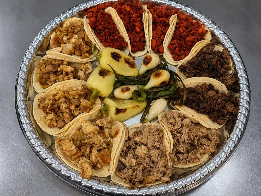 Family taco tray at Goyo Tacos with chorizo, carnitas, pastor and grilled spring onions and chiles