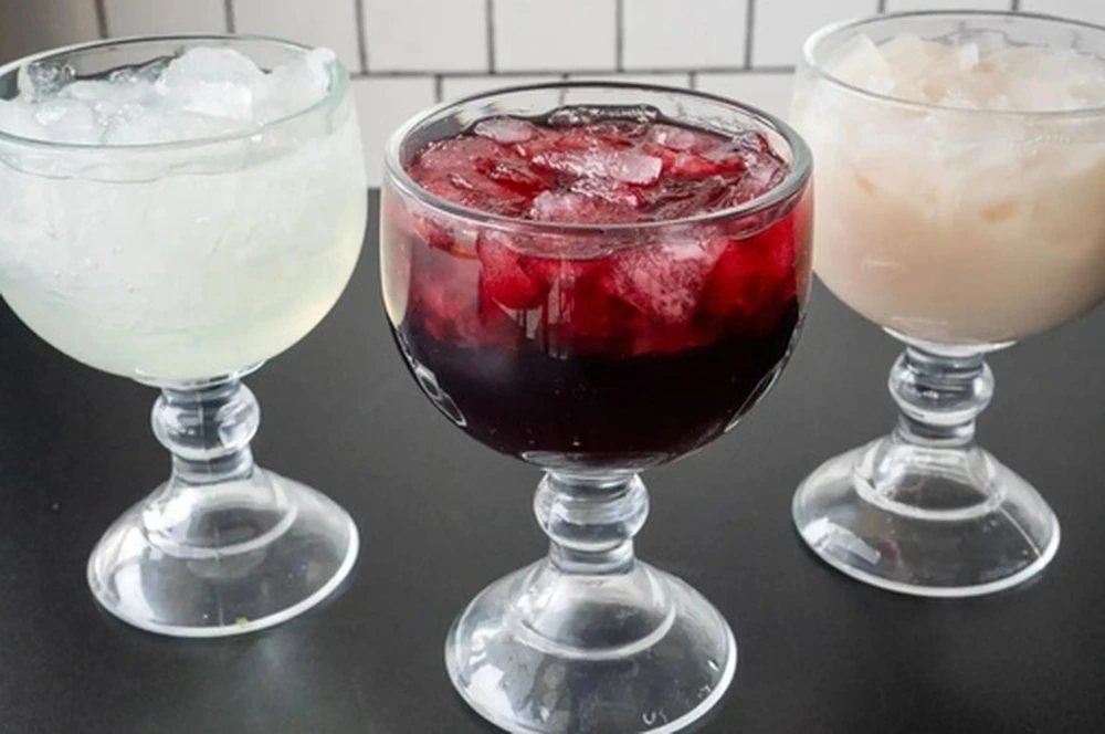 Three aguas frescas over ice: limón con pepino, jamaica and horchata